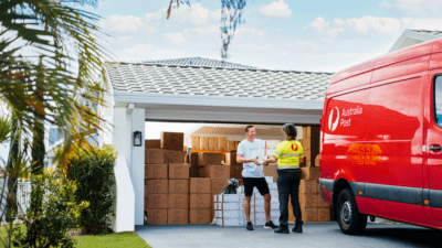 photo-man-standing-in-driveway-with-delivery-person-garage-filled-with-boxes.png.auspostimage.970_0.medium